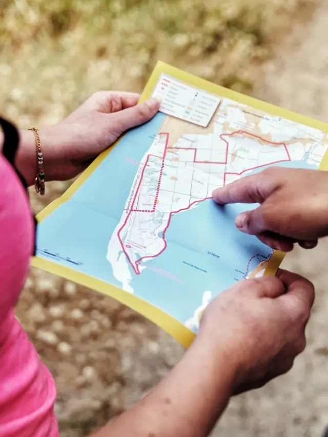 Two people looking at a map to plan a hike