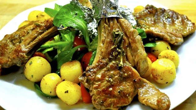 Plate of grilled meat, potatoes, and vegetables