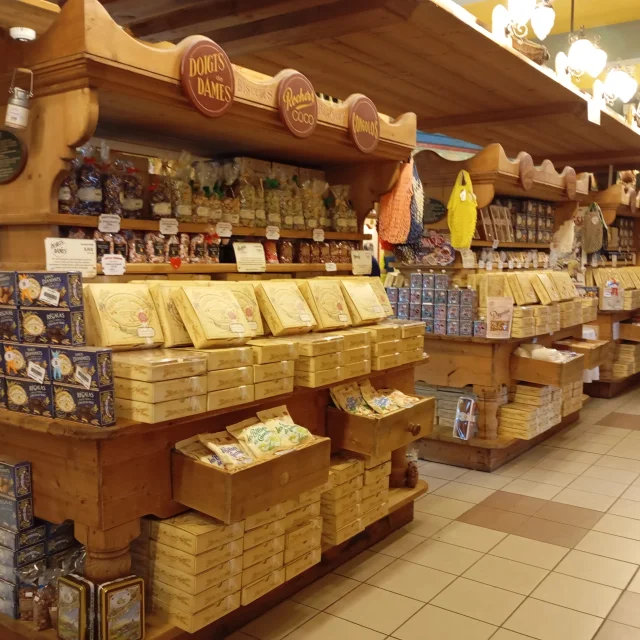Shelves filled with various types of packaged cheeses