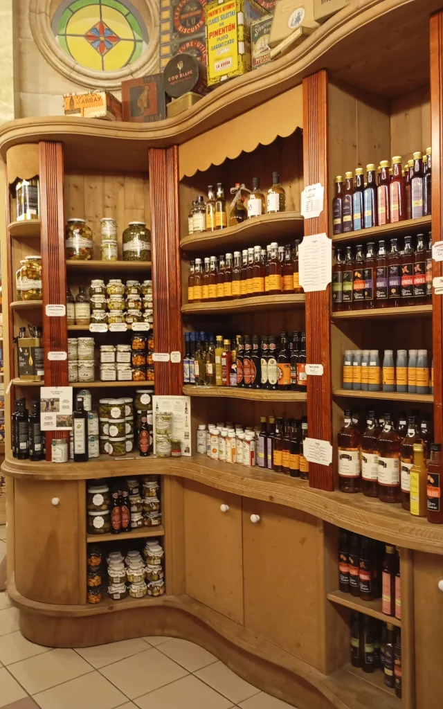 Wooden shelves filled with bottles, jars, and boxes of artisanal products